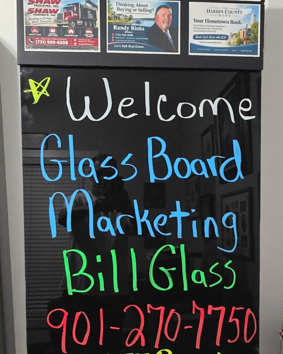 A Glass Board Marketing welcome board with six advertiser cards across the top